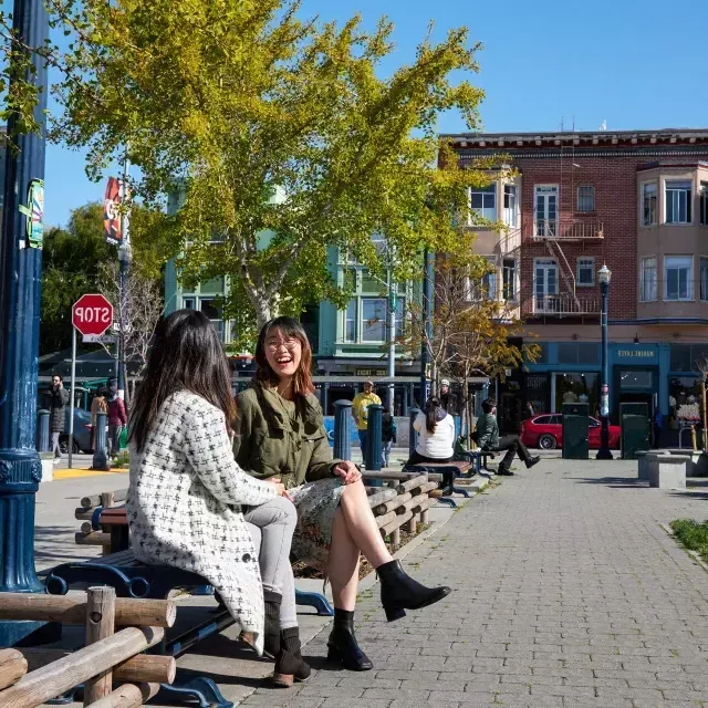 Women sit outside at Patricia's Green in San Francisco's Hayes Valley.